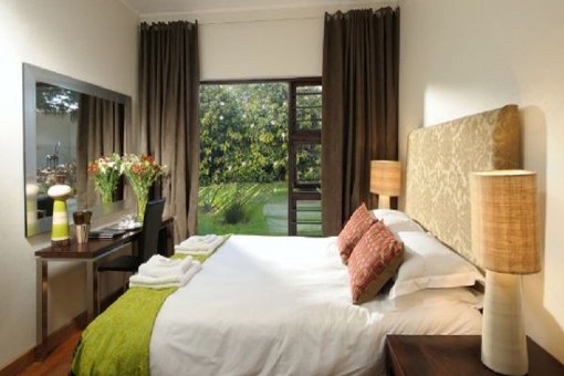 Bedroom with big mirror and view to garden